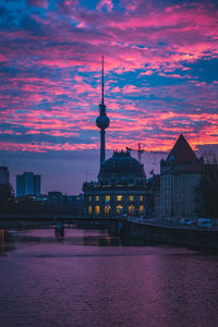 View of buildings against cloudy sky at sunset