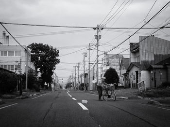 Rear view of vehicles on road by buildings in city