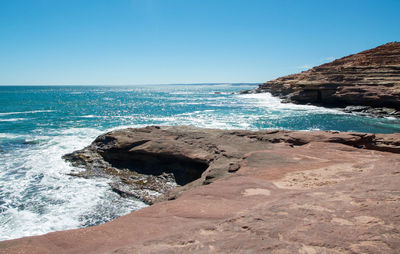 Scenic view of sea against clear blue sky