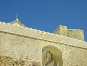 Low angle view of built structure against blue sky