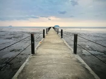 Pier over sea against sky