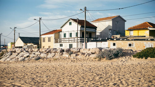 Houses in town against sky