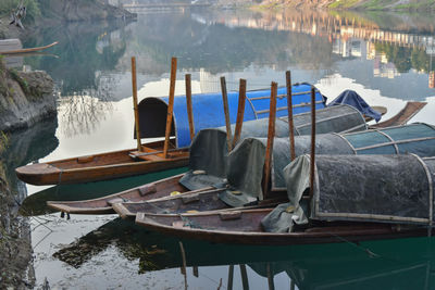 Boats moored on wooden post at lake