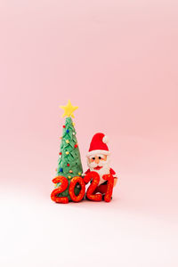 Close-up of christmas decoration against colored background