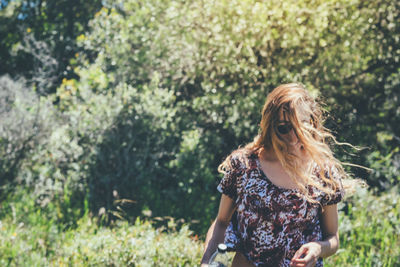 Woman standing against plants