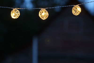 Close-up of illuminated lights outdoors at night