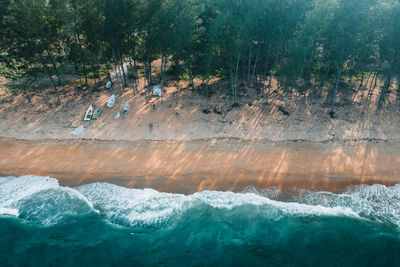 Scenic view of sea against trees in forest