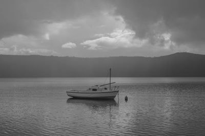 Boat sailing in sea against sky