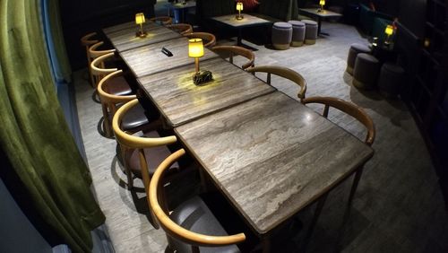 High angle view of empty chairs and table in restaurant