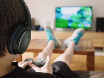 Boy playing video game at home