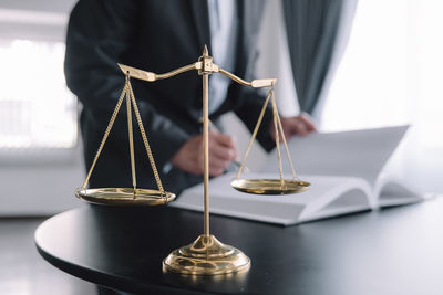 Midsection of woman holding trophy on table