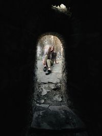 People sitting in tunnel