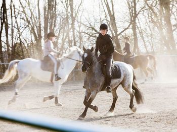 Three girls riding on horse