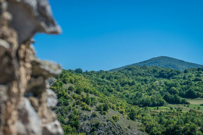 Low angle view of mountain against clear blue sky