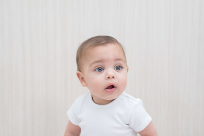 Portrait of cute baby against wall