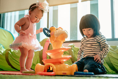 Cute boy playing with toy toys