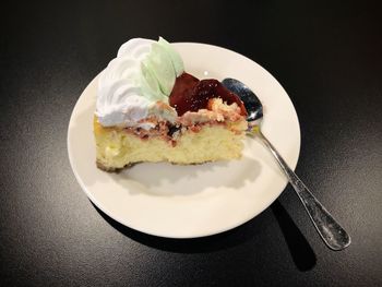 High angle view of strawberry cheesecake in plate on table