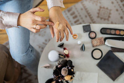 High angle view of people holding hands on table