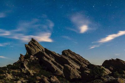 Low angle view of mountain against sky at night