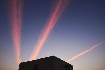 Low angle view of building against sky during sunset