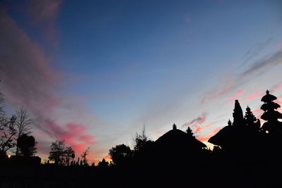 Low angle view of silhouette trees against sky during sunset