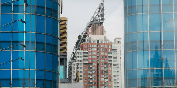 Low angle view of modern buildings against clear blue sky