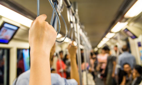 Cropped image of man holding train