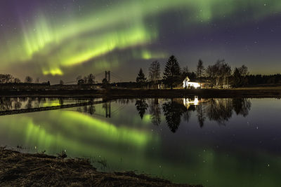 Scenic view of lake against sky at night