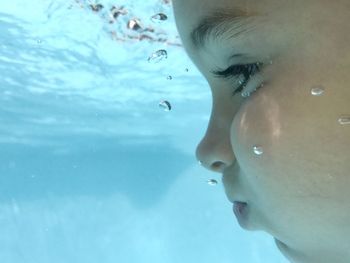 Close-up portrait of boy swimming in pool