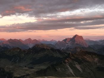 Scenic view of mountains against cloudy sky