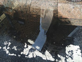 Reflection of buildings in puddle