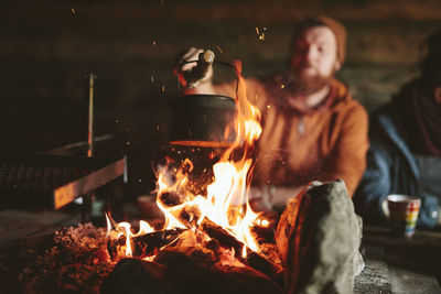 High angle close up of kettle over camp fire in a forest. stock photo