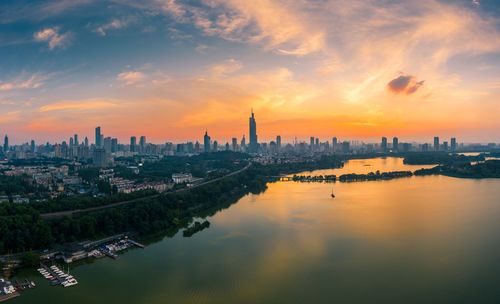 Panoramic view of buildings in city against sky during sunset