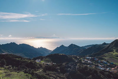 Scenic view of mountains against blue sky