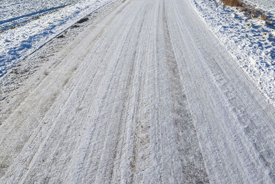 High angle view of tire tracks on road