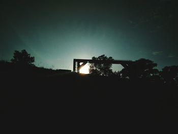 Low angle view of silhouette trees against clear sky