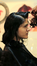 Close-up portrait of young woman looking away