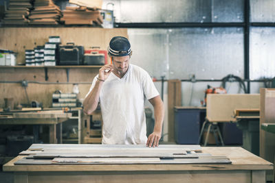 Carpenter working at workbench in workshop