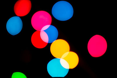 Close-up of multi colored lights against black background