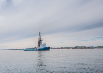 A tug boat on its way on calm seas
