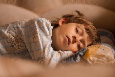 High angle view of baby sleeping in bed