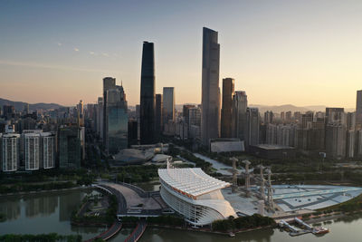 Aerial view of buildings in city against sky