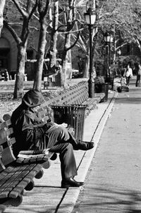 Man sitting on footpath in park