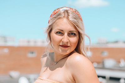 Portrait of beautiful young woman standing outdoors