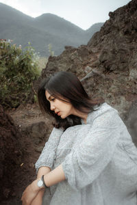 Midsection of woman standing on mountain