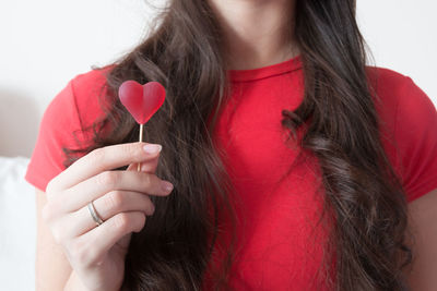 Close-up of woman holding heart shape