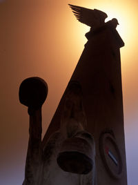 Low angle view of tower against sky during sunset