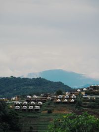Houses on field against sky