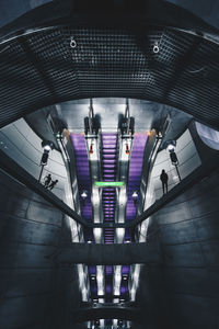 High angle view of man on illuminated escalator