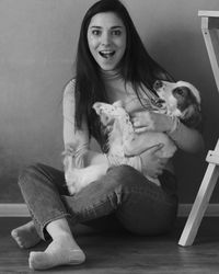 Portrait of smiling young woman sitting at home